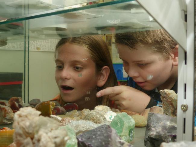 Riley Hudson, 12, and Dayne Lee, 11, check out the Townsville Gem and Mineral Club's chock-a-block display cabinet, as the club prepares for its largest fundraising event of the year, the annual gem show, to be held on July 22 and 23. Picture: Blair Jackson