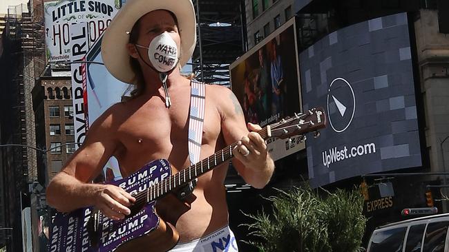 The famous Naked Cowboy continues to perform in Times Square - but uses a mask. Picture: AFP.