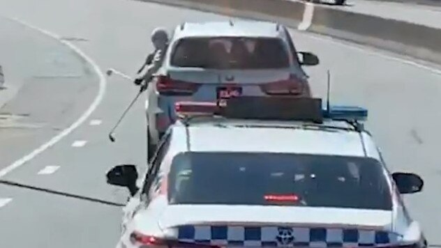 Two passengers shown on video taunting police with golf clubs on a busy freeway.