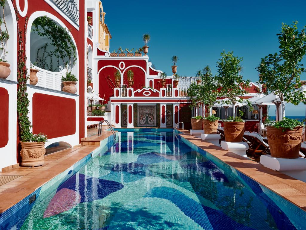 The hotel is recognisable for its crimson red exterior.