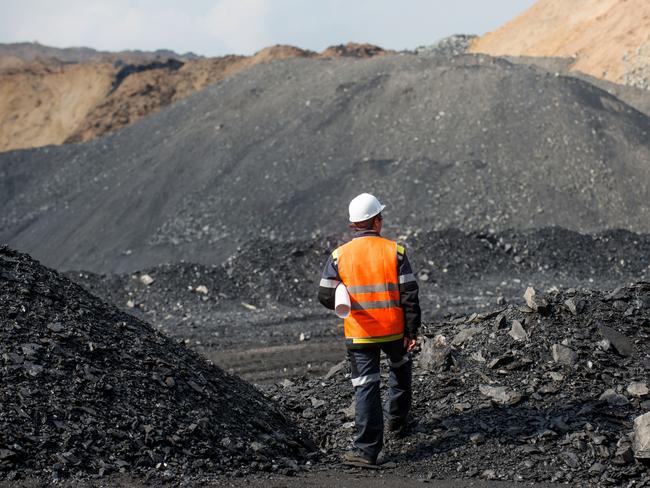 Coal mining in an open pit - Worker is looking on the huge open pit