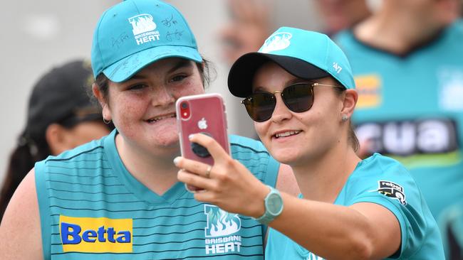 World number one tennis player Ashleigh Barty (right) is seen taking a selfie photograph with fans during the Women's Big Bash League (WBBL) cricket match between Brisbane Heat and Melbourne Renegades.