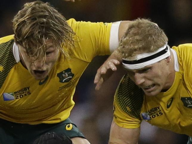 Fiji's Netani Talei is tackled by Australia's David Pocock, right, and Michael Hooper during the Rugby World Cup Pool A match between Australia and Fiji at the Millennium Stadium, Cardiff, Wednesday, Sept. 23, 2015. (AP Photo/Matt Dunham)