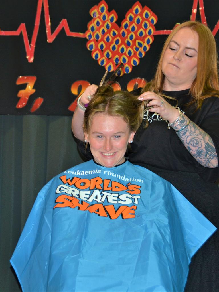 At the St Joseph's College 2023 World's Greatest Shave event is student Romey Wiemers getting her hair cut by hairdresser Rebecca Mortlock from the Hair Room on Russell. Picture: Rhylea Millar