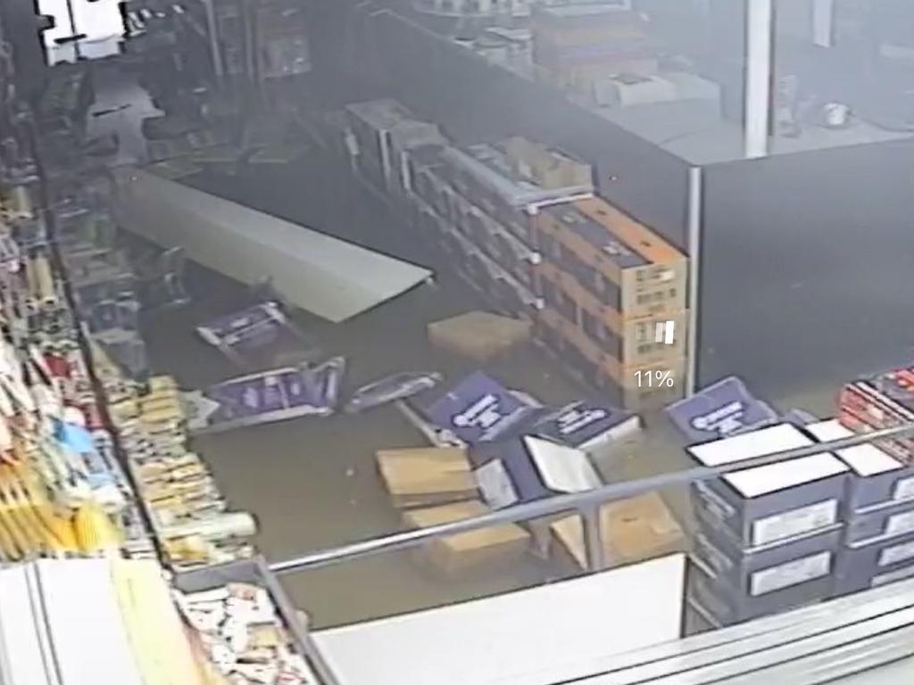 CCTV footage from Inspirations Paint, Pialba shows boxes and other store items floating in the floodwater.