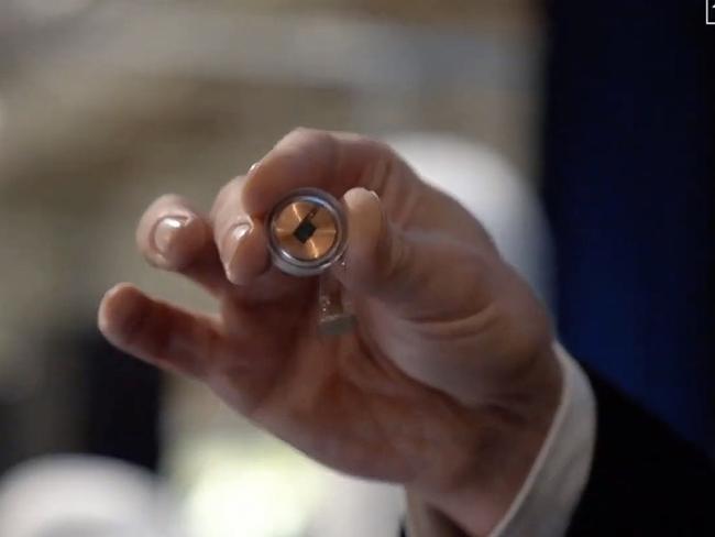 The Neuralink disk implant held by Elon Musk. Picture: Neuralink/AFP