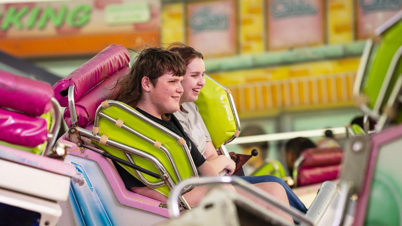 Siblings Jayden and Ally Halter ride the Cyber Dance Cafe at the Toowoomba Royal Show, Thursday, March 30, 2023. Picture: Kevin Farmer