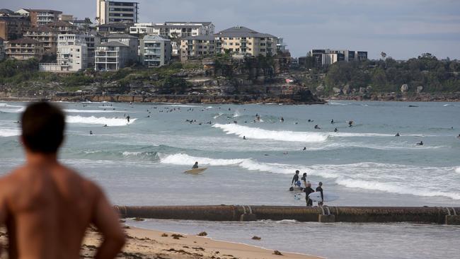 People exercise at Manly Beach in Sydney’s north on Sunday. Picture: Damian Shaw