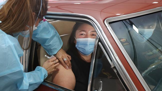 A driver gets the jab at a makeshift vaccination centre at an old Ford factory site in Campbellfield. Picture: David Crosling