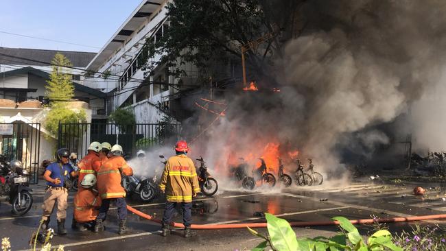 Firefighters try to extinguish a blaze following a blast at the Pentecost Church Central Surabaya (GPPS), in Surabaya, East Java, Indonesia May 13, 2018, in this photo provided by Antara Foto. Antara Foto/ Handout Surabaya Government/ via REUTERS ATTENTION EDITORS - THIS IMAGE WAS PROVIDED BY A THIRD PARTY. MANDATORY CREDIT. INDONESIA OUT. - RC1D99D1ADF0