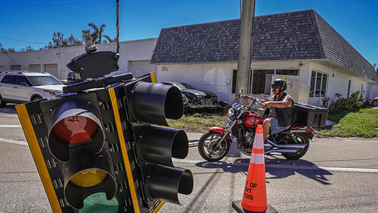 A traffic light hangs near ground level at a street intersection in the aftermath of Hurricane Ian in Fort Myers Beach, Florida. Picture: AFP