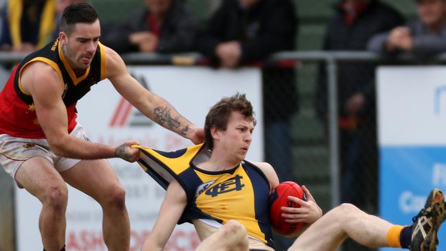 Fitzroy Stars’ Jai Burns lays a big tackle on Hurstbridge's Tom Grimes. Picture: Brendan Francis