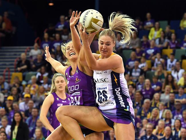 Laura Geitz of the Firebirds (left) and Caitlin Bassett of the Lightning contest the ball during the Super Netball Minor Semi Final match between the Queensland Firebirds and the Sunshine Coast Lightning at the Brisbane Entertainment Centre in Brisbane, Sunday, August 12, 2018. (AAP Image/Dave Hunt) NO ARCHIVING, EDITORIAL USE ONLY