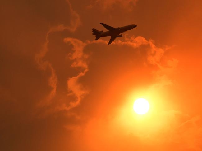 A DC-10 Air Tanker makes a pass to drop fire retardant on a bushfire in North Nowra, 160km south of Sydney, Saturday, January 4, 2020. Bushfires are spreading rapidly as weather conditions continue to deteriorate on a day of extreme fire danger for large parts of NSW. (AAP Image/Mick Tsikas) NO ARCHIVING