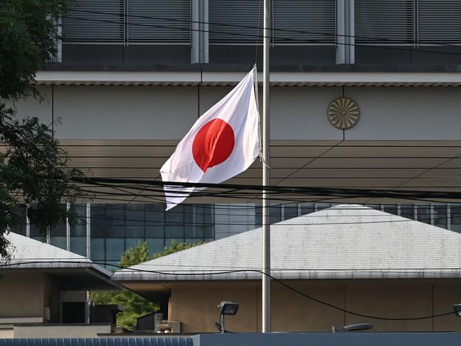 The Japanese flag flies at half mast at the Japanese embassy in Beijing on September 19, 2024. China on September 19 expressed "regret and sadness" after a Japanese schoolboy who was stabbed in the southern city of Shenzhen died of his injuries. (Photo by GREG BAKER / AFP)