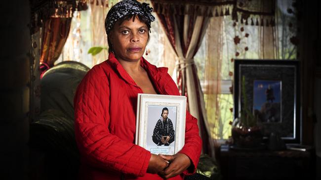 Hirut Weldemicheal holds a picture of her son, Nazrawi Samson Woldemichael, who has been missing for nearly 4 years. Picture: CHRIS KIDD