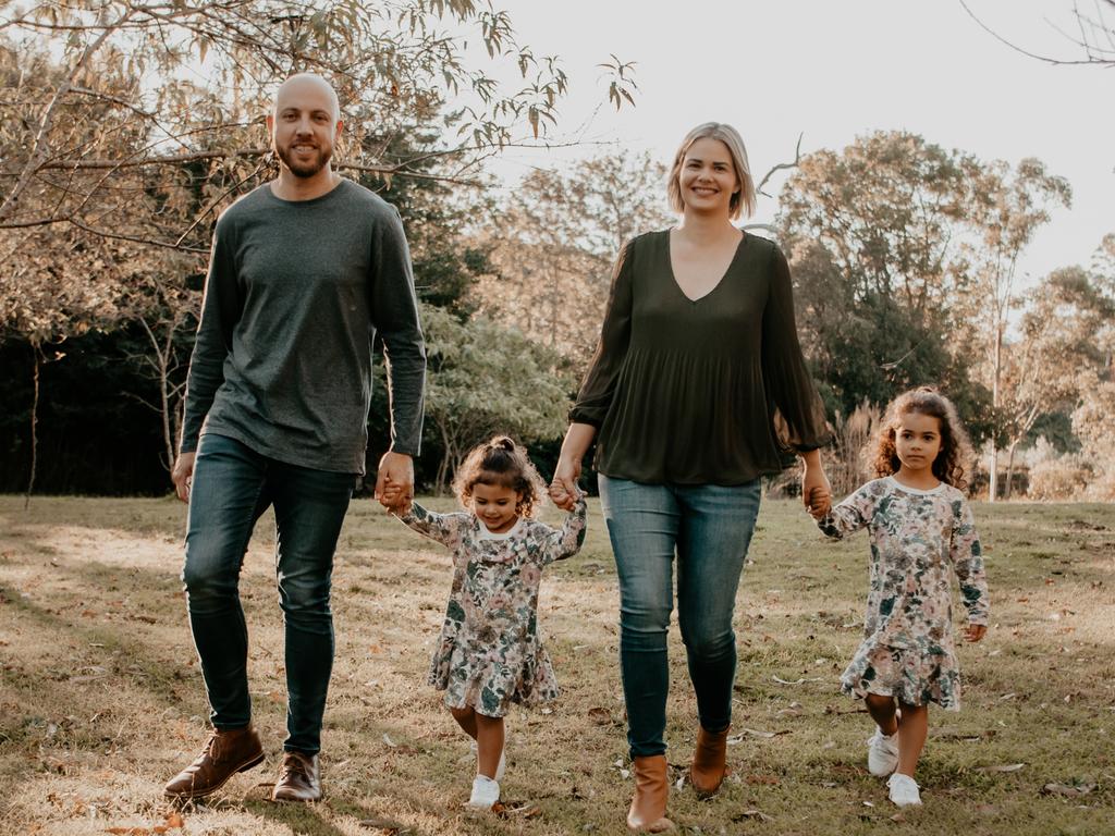 Amy Crisafulli, 35, with husband Dan, 36, and two girls Eliza, 5, and Adalyn, 3, of the Gold Coast. The couple say expensive childcare fees have played a major part in not having a third child. Credit: Zoe Rane Photography.