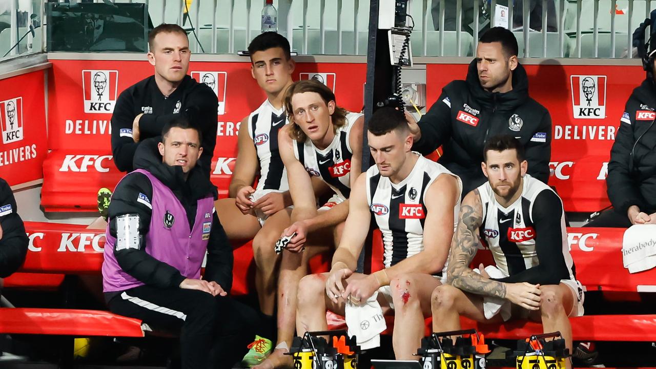 Nick Daicos and Nathan Murphy of the Magpies are seen in the back row of the bench. Picture: Dylan Burns/AFL Photos via Getty Images