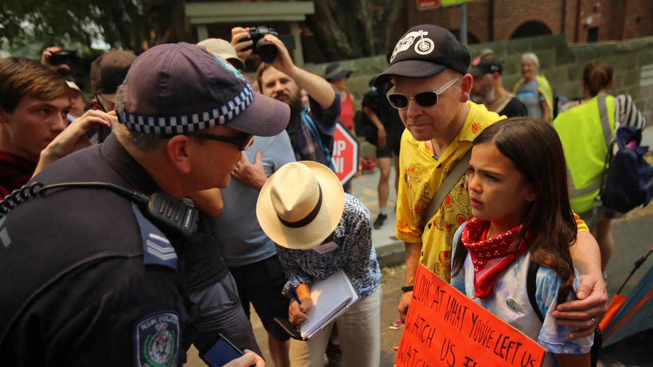 The young girl who went viral after footage of police threatening to arrest her father during a protest outside Kirribilli House has spoken out. Picture: AAP Image/Steven Saphore