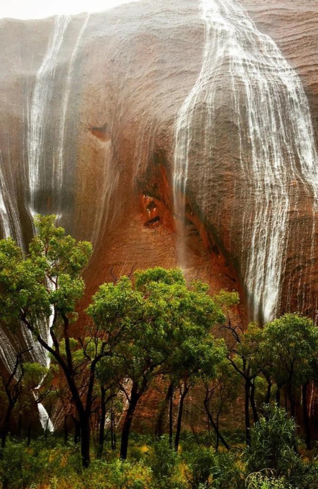 Waterfalls at Uluru as heavy rain across the Northern Territory has forced the closure of the National Park. Picture: Instagram / Paul Manning