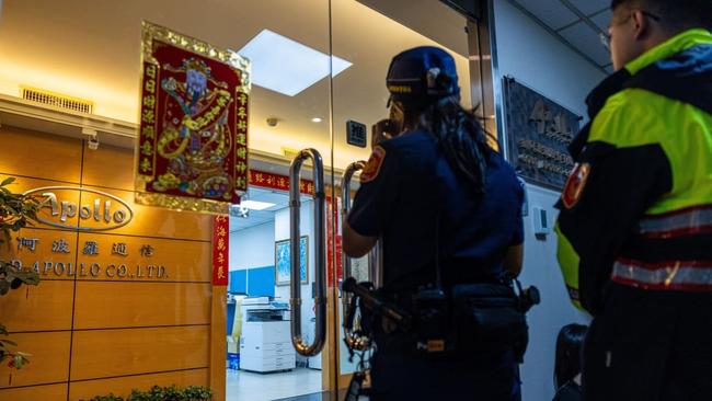 A police officer attempting to enter an office of Gold Apollo, in Taiwan, where the pager trail started. Photo: Annabelle Chih/Getty Images