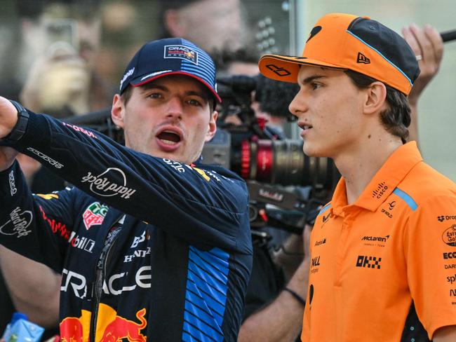 Red Bull Racing's Dutch driver Max Verstappen (L) and McLaren's Australian driver Oscar Piastri arrive ahead of the Abu Dhabi Formula One Grand Prix at the Yas Marina Circuit in Abu Dhabi on December 8, 2024. (Photo by Andrej ISAKOVIC / AFP)