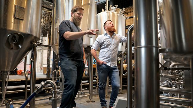 Jarred ‘Red’ Proudfoot and The District venue manager Jarrad Anderson in the Pirate Life microbrewery at SkyCity Adelaide. Picture: Dean Martin