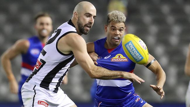 AFL Round 1. Western Bulldogs v Collingwood at Marvel Stadium..  21/03/2020.  Steele Sidebottom of the Magpies and Jason Johannisen of the Bulldogs battle for the loose ball  . Pic: Michael Klein