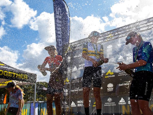 Izzy Flint celebrates on the podium after her victory at the National Mountain Bike Championships. Picture: AusCycling/Matt Rousu