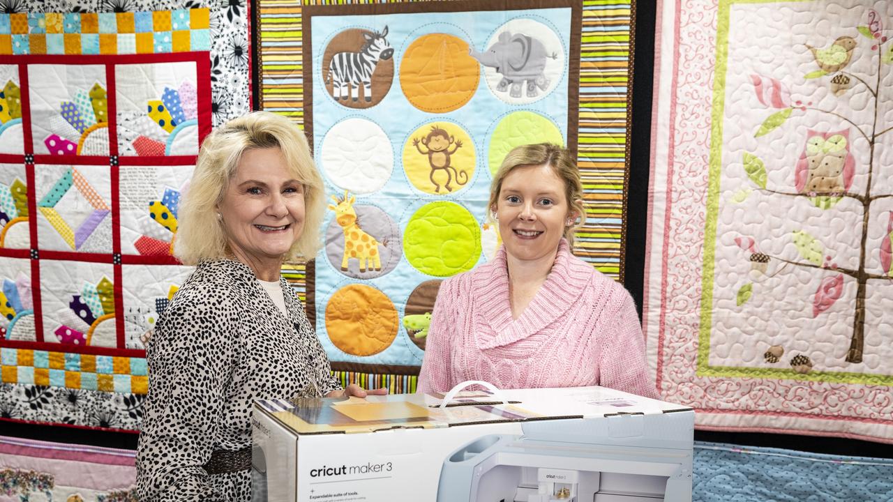 Kaylene Leicht and daughter Hanna Redding with Hanna's newly purchased cricut maker in the Toowoomba Quliters Club exhibit of Craft Alive at the Goods Shed, Sunday, May 22, 2022. Picture: Kevin Farmer