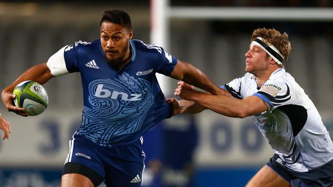 George Moala of the Blues is tackled by Kyle Godwin of the Western Force.