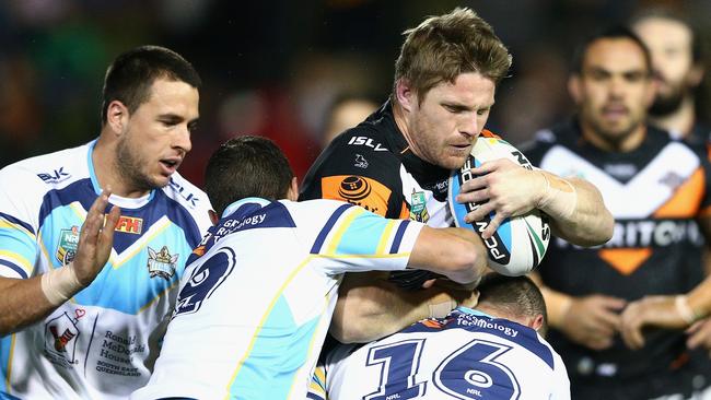 SYDNEY, AUSTRALIA - JUNE 05: Christopher Lawrence of the Tigers is tackled during the round 13 NRL match between the Wests Tigers and the Gold Coast Titans at Leichhardt Oval on June 5, 2015 in Sydney, Australia. (Photo by Cameron Spencer/Getty Images)