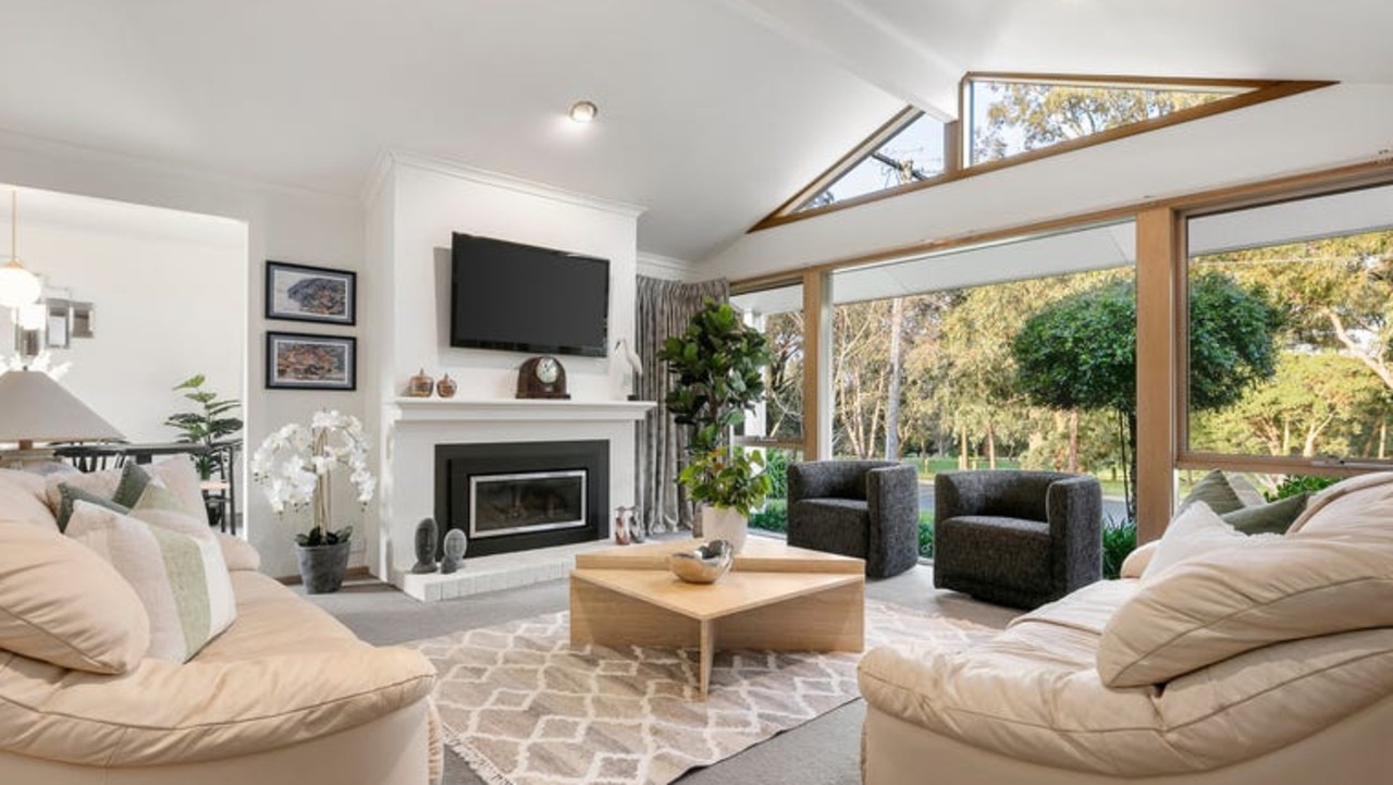 A picture window looks out to the golf course in the fireside lounge room.