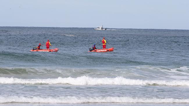 Surf lifesavers search for a shark that attacked a man at Lighthouse Beach at Ballina. Photo: David Clark