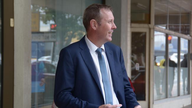 Groom MP Garth Hamilton hands out how-to-vote cards outside the federal election early voting centre in the Toowoomba CBD.