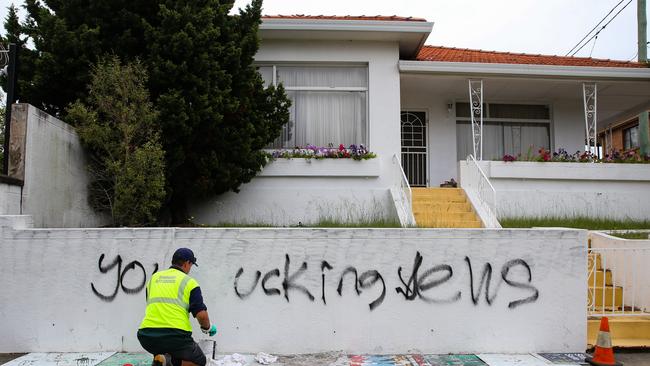 A council worker removes anti-Semitic graffiti outside a house next door to the Mount Sinai College in Maroubra. Picture: NewsWire/ Gaye Gerard