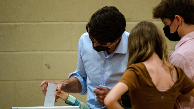 Justin Trudeau casts his vote as his children watch. Picture: AFP.