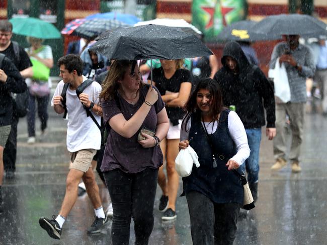 Lucky for these guys they didn’t forget an umbrella. Picture Alex Coppel.