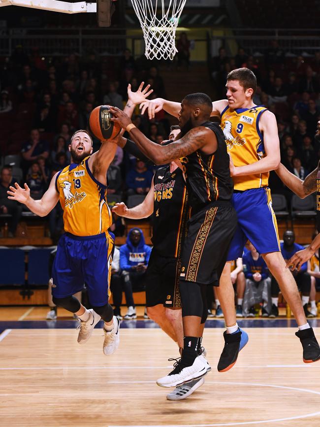 Import CJ Turnage, pictured with the ball in Southern’s grand final win over Forestville last year, has returned to the Tigers for a second season. Picture: AAP/Mark Brake