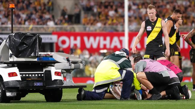 Jack Riewoldt watches on as the stretcher is brought out for Vlastuin. Picture: Getty