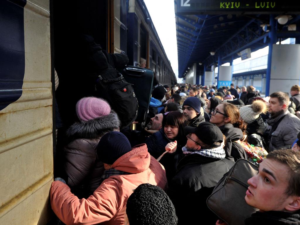 People try to get an evacuation train at Kyiv central train station after Ukraine accused the Kremlin of "nuclear terror". Picture: AFP.