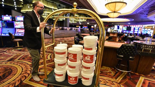 A casino worker distributes buckets of sanitising wipes at Caesars Palace. Picture: Getty Images