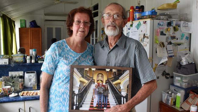 Graham Board and companion Denise Bowen at the couple's Ingham home. Mr Board is holding a photograph of daughters Jennifer and Siana taken during a holiday in Peru in 2017. Photograph: Cameron Bates