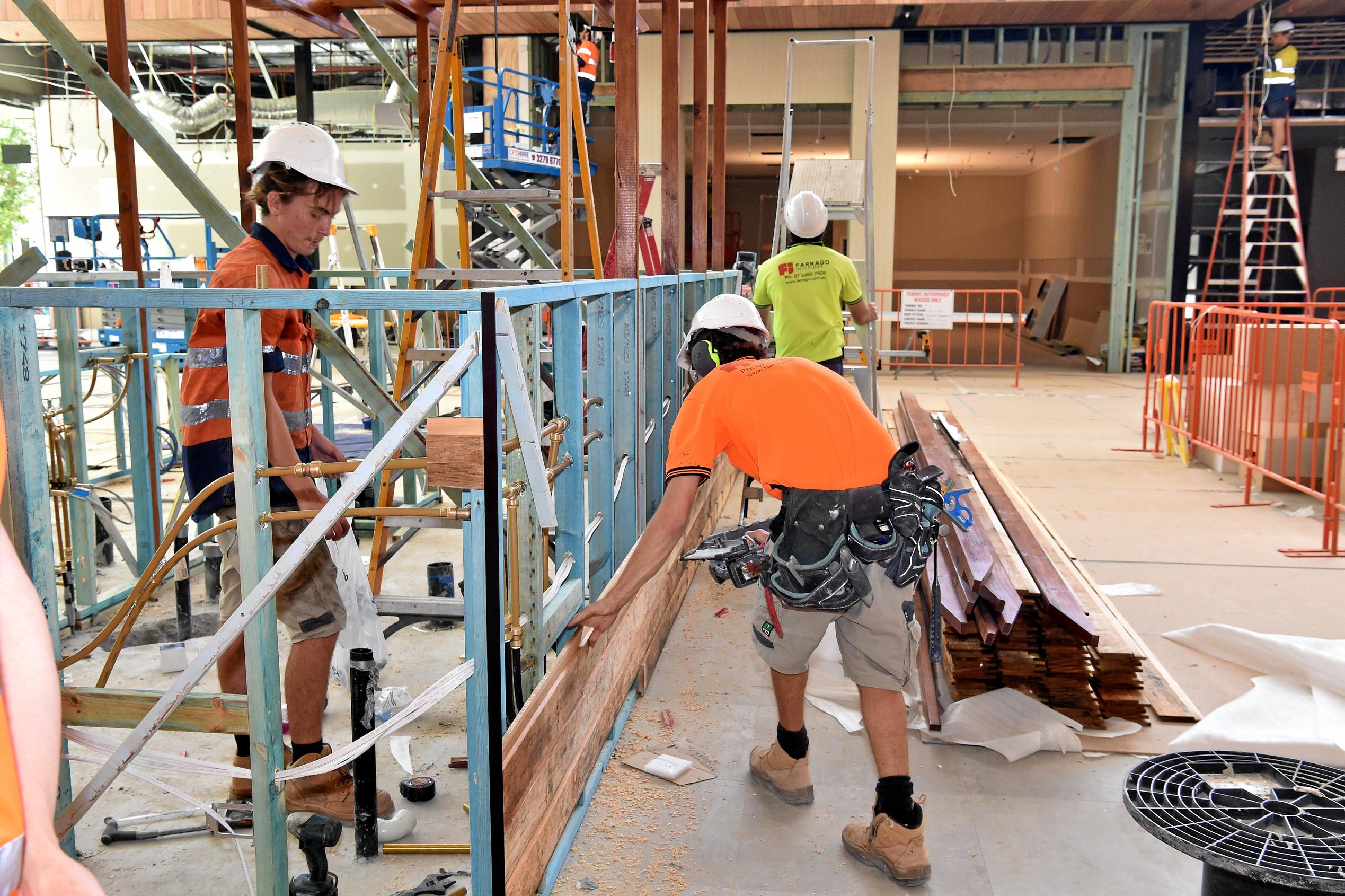 Full steam ahead for the opening of the Stockland Birtinya Shopping Centre. Constuction workers put the final pieces together for the grand opening in a couple of weeks. Picture: Warren Lynam