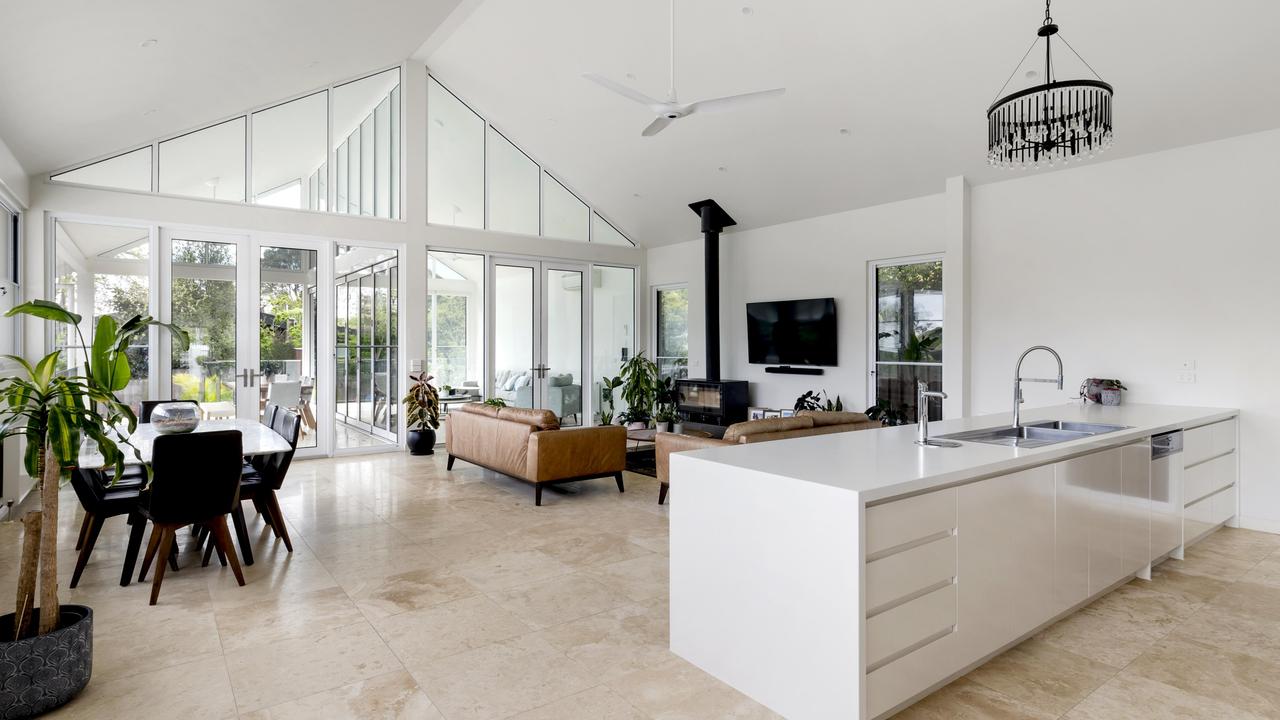 The kitchen is fitted with Miele appliances and a stone island bench.