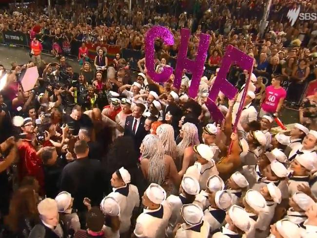 A sign is held up during the parade honouring Cher. Picture: SBS