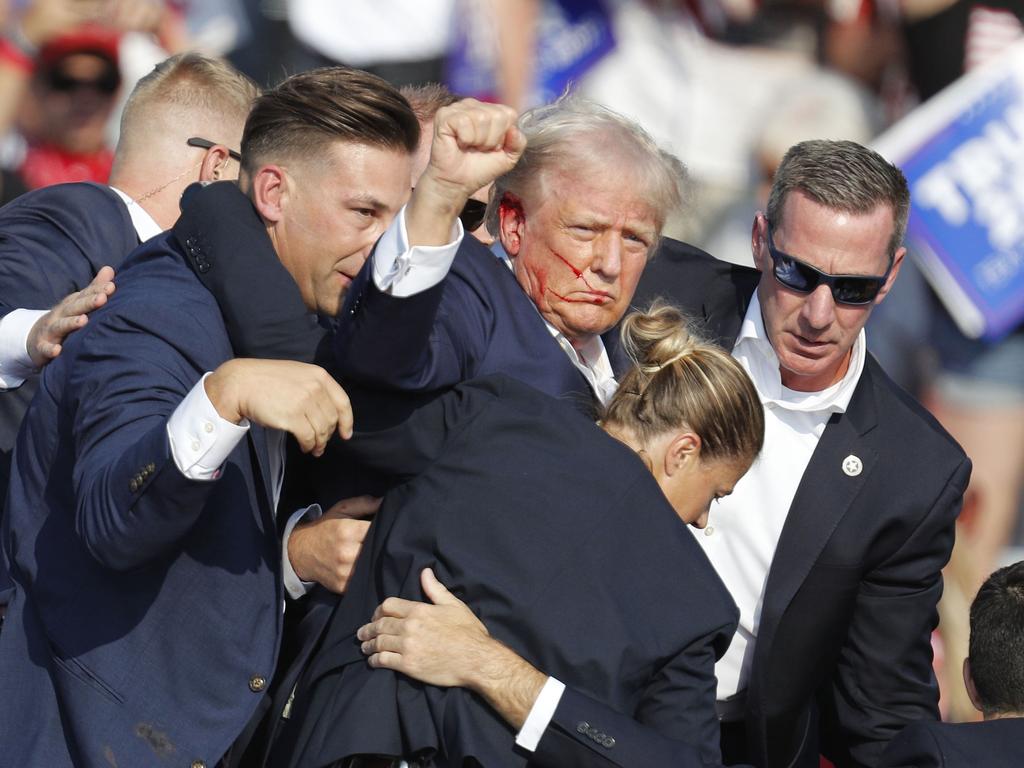 Former US President Donald Trump is rushed off the after the shooting. Photo: EPA