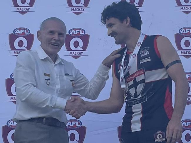 Alec Townsend (right) was best-on-ground for the North Mackay Saints in the AFL Mackay senior men's grand final. Club legend Frank Zeolla is pictured presenting him with the award. Picture: AFL Queensland.