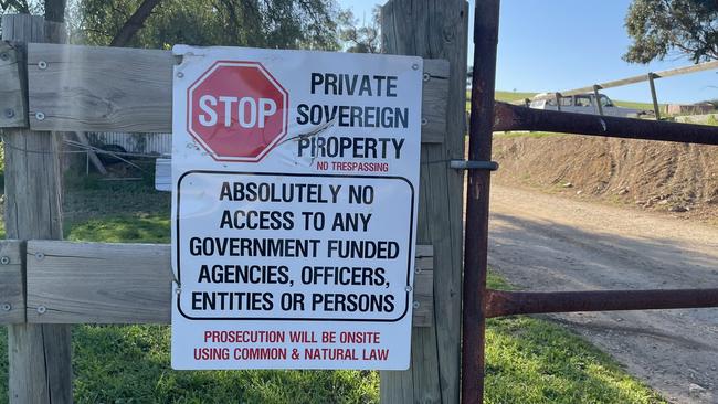 One of the signs outside of the Sandy Creek property, declaring it to be private sovereign property. Picture: Jason Katsaras