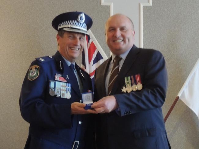 Inspector Stephen Fowler with Police Minister David Elliott.